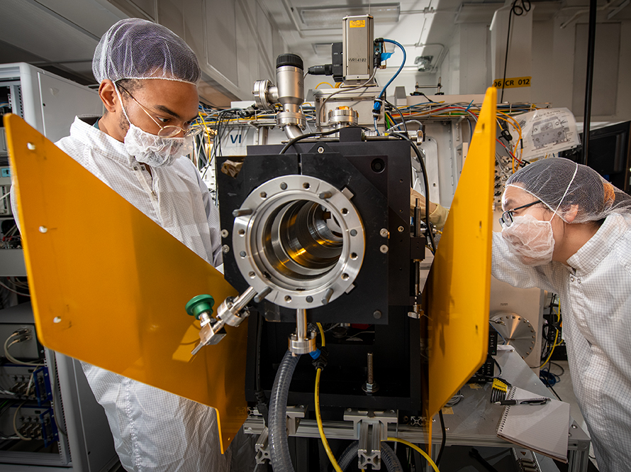 Researchers inspect a mirror chamber at the CXRO beamline at the Advanced Light Source.