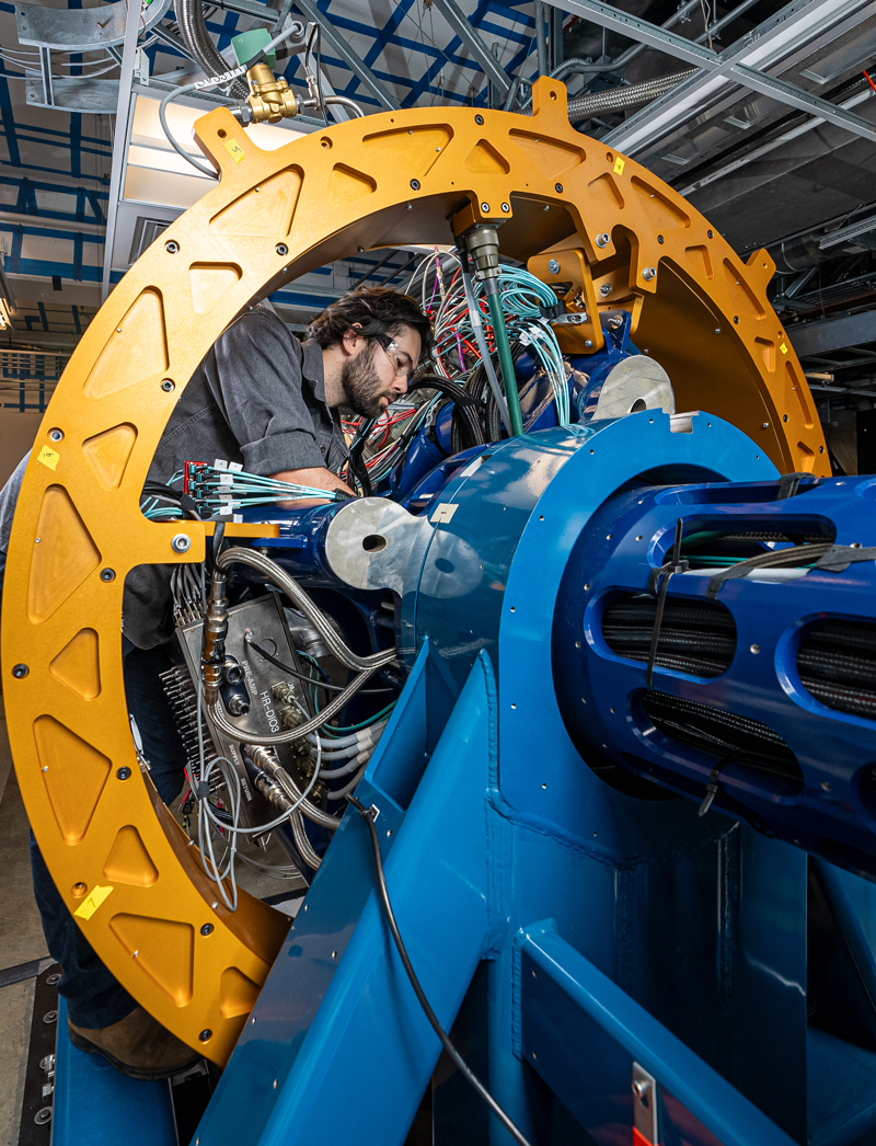 A mechanical engineering technician examining connections on GRETA
