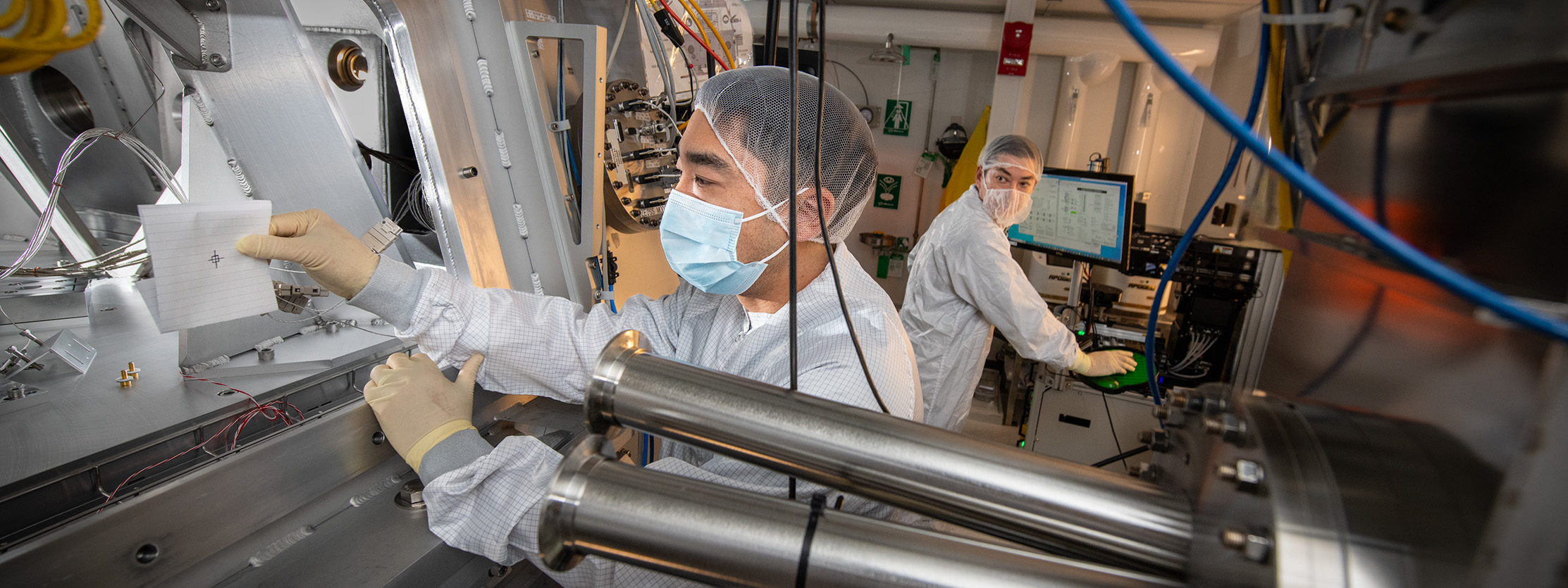 Scientists check the alignment of light as it enters the CXRO high-resolution camera at the Advanced Light Source.