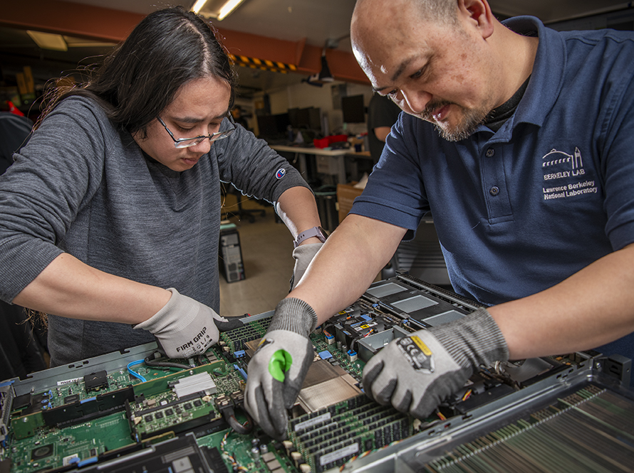 Systems Specialists repair a server in the Lab.