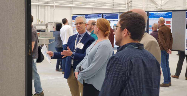 A small group discussing a poster
