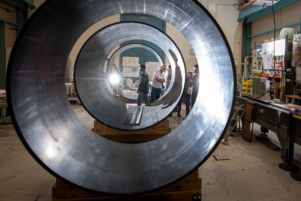 The ATLAS ITk outer cylinder under construction with onlookers in the background