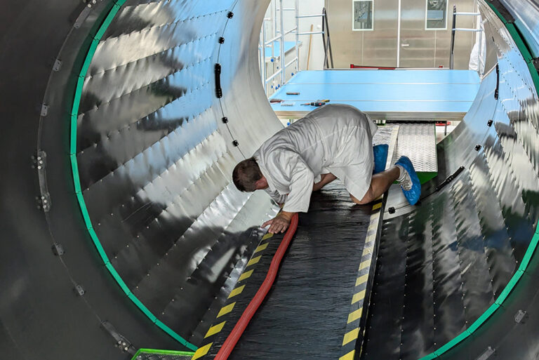 A worker installs the polymoderator tiles in the cylinder