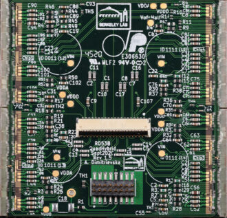Assembled quad module circuit board with four chips connected to central sensor tile
