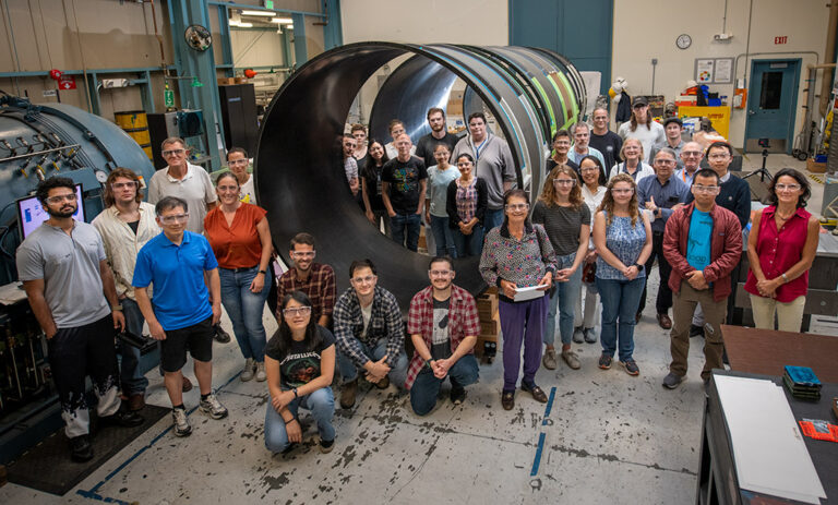 Members of the ATLAS team posing with the outer cylinder