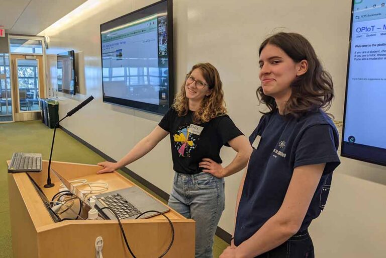 A student presenter and a ATLAS postdoc at the podium