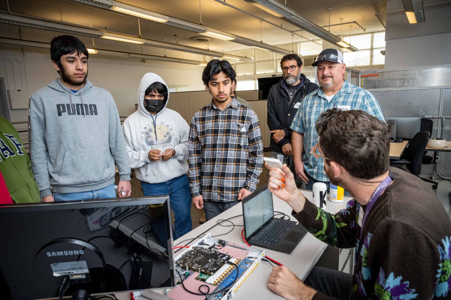 An electronics engineer demos the workings of a low-level RF component to high school students