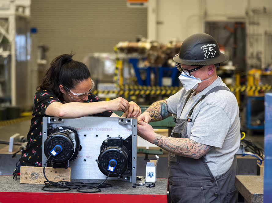 Engineers work on a Turkshead wire puller upgrade at the Building 77 machine shop.