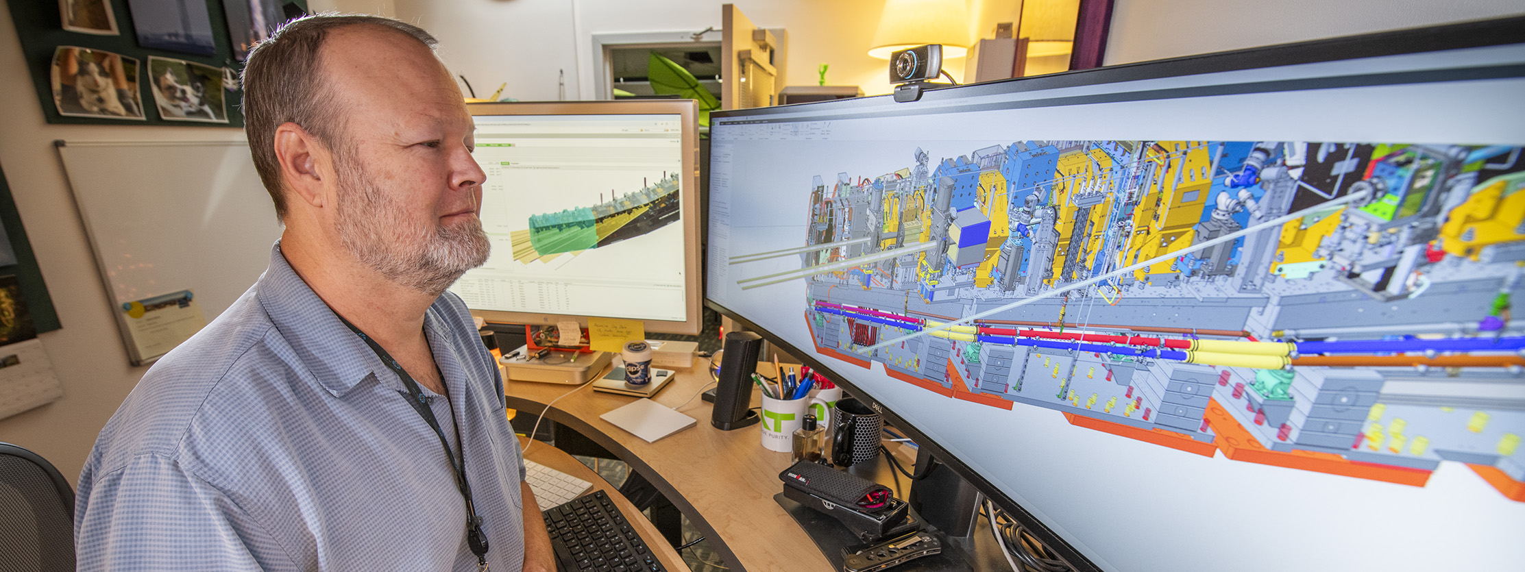 Engineer reviewing CAD rendering.