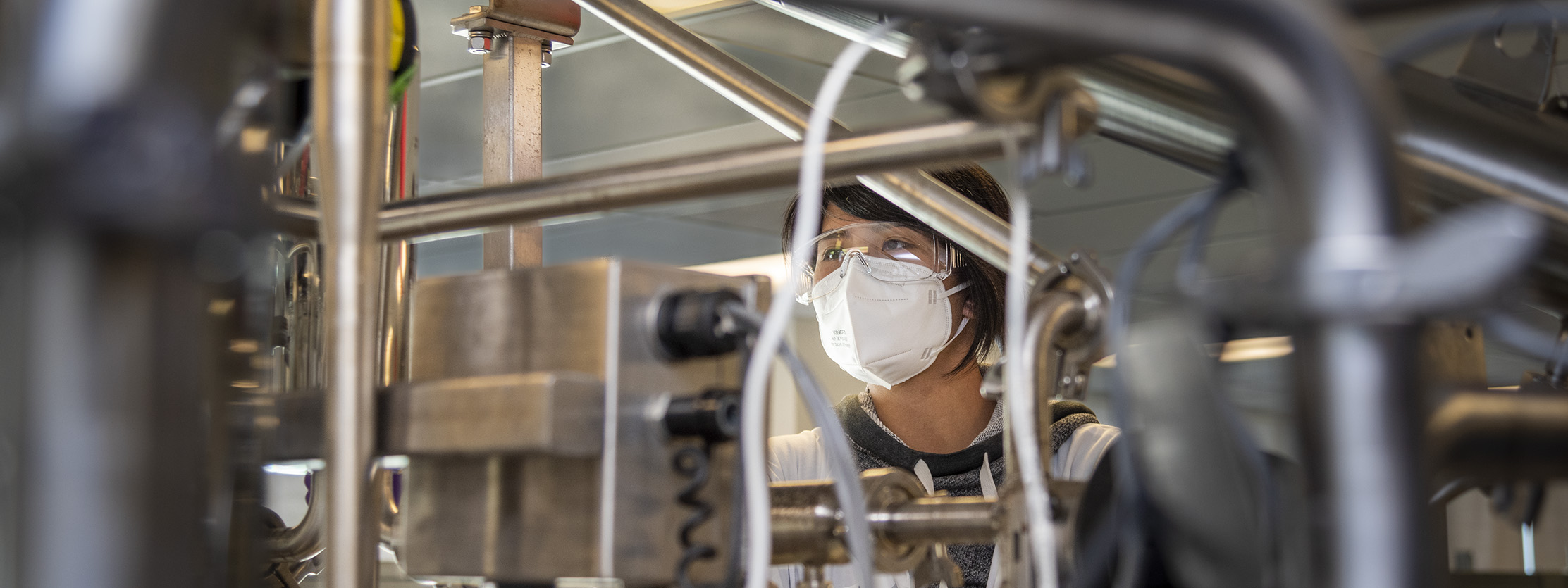 Student adjusts the controls of a bioreactor.