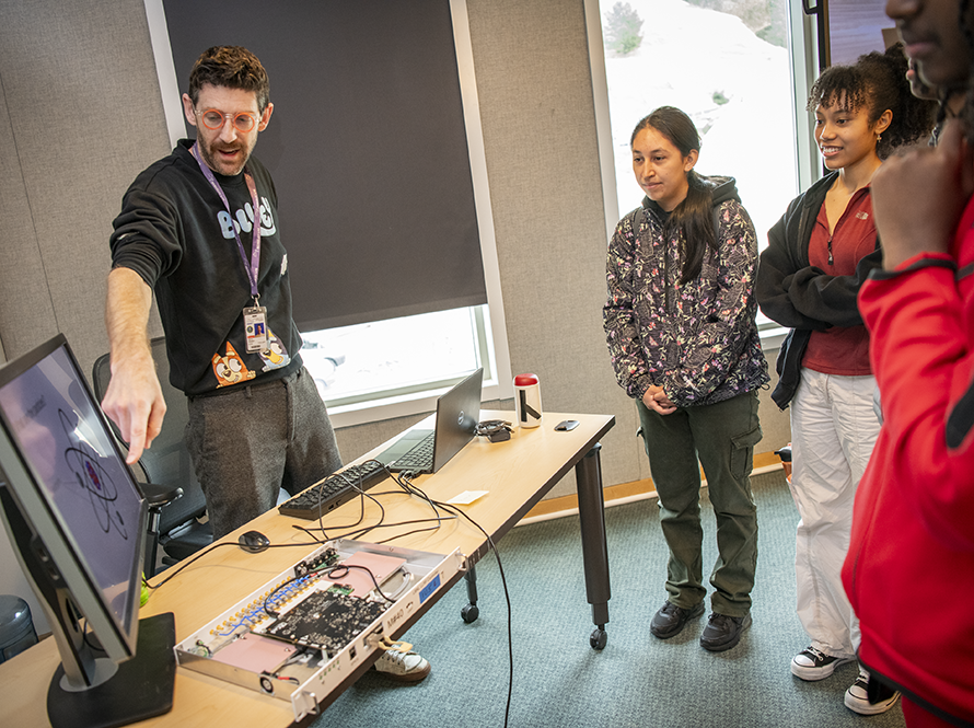 Electronics engineer presenting to high school students.