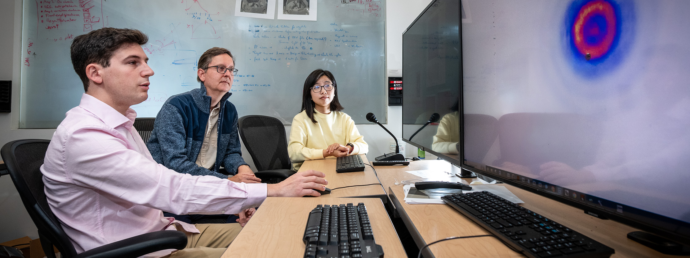 Researchers discuss the results of a test on the PW Laser at the Berkeley Lab Laser Accelerator (BELLA).