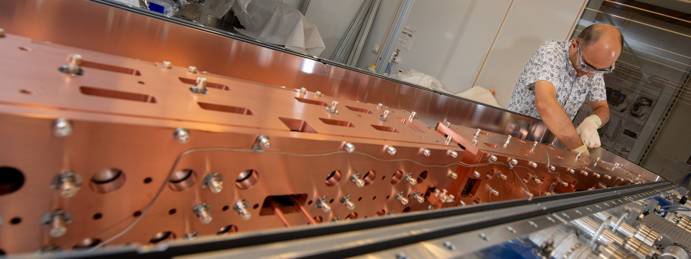 An Engineer makes adjustments on the equipment which will be installed into the Advanced Light Source (ALS) accelerator tunnel.