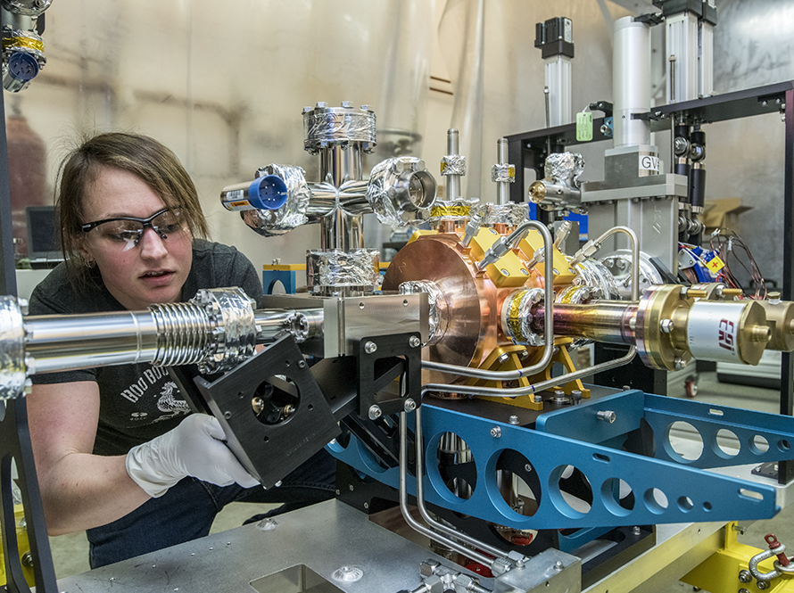Engineer working on a complex component for LCLS-II.