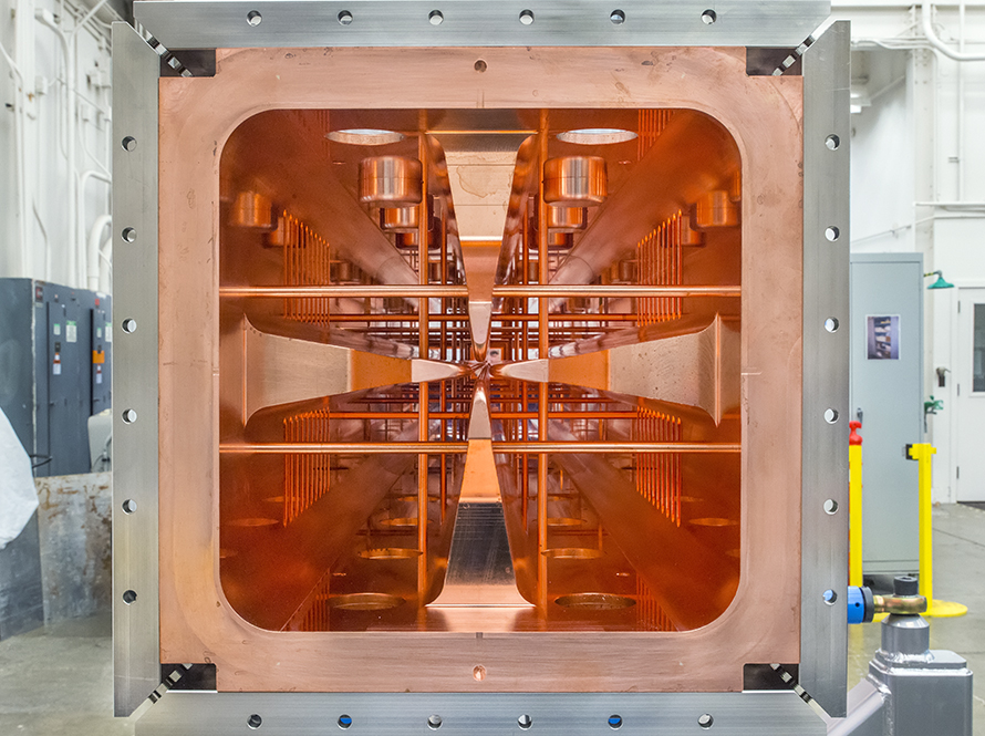 Cross-sectional view of a radio-frequency accelerator showing copper interior components.
