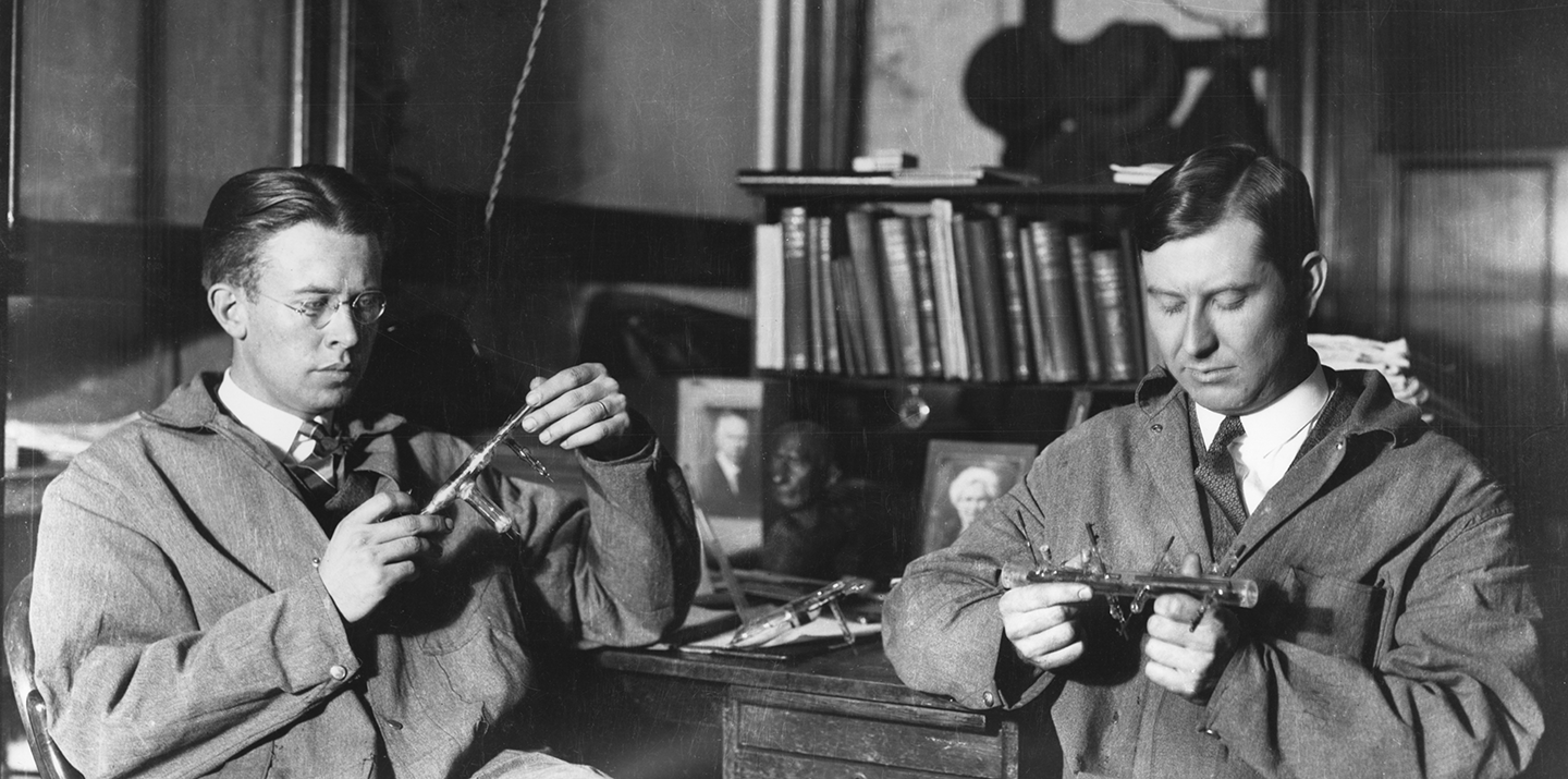 Ernest Lawrence and Jesse Beams working with experimental apparatus in a laboratory setting at Yale University.