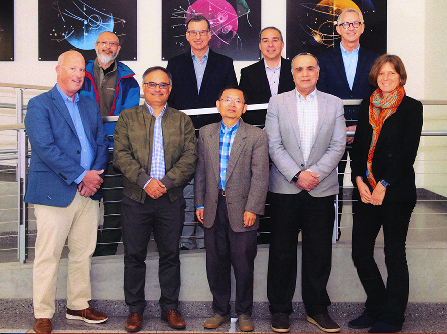 Team of people posed for photo.