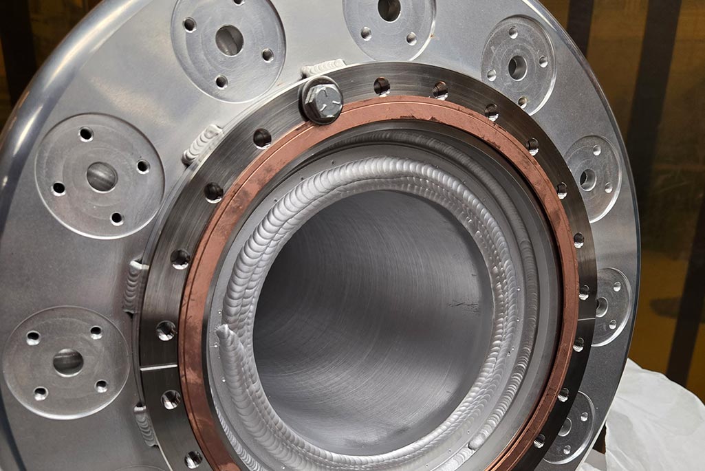 A closeup view of the flange for the third-generation VENUS plasma chamber. The device was made in-house by the Engineering Division’s highly skilled technicians.