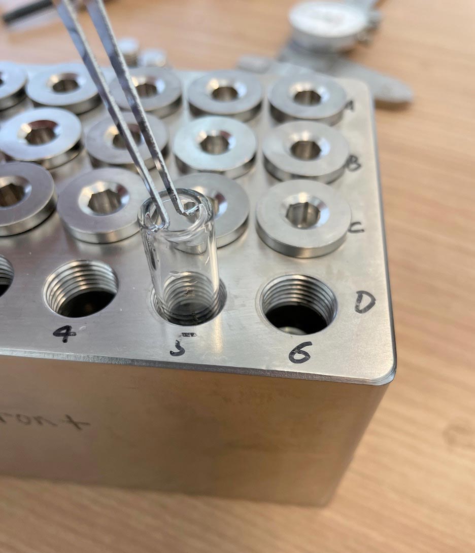 Custom-designed glass liners with a special lip that allows for easy insertion and removal from the small-batch reactor.