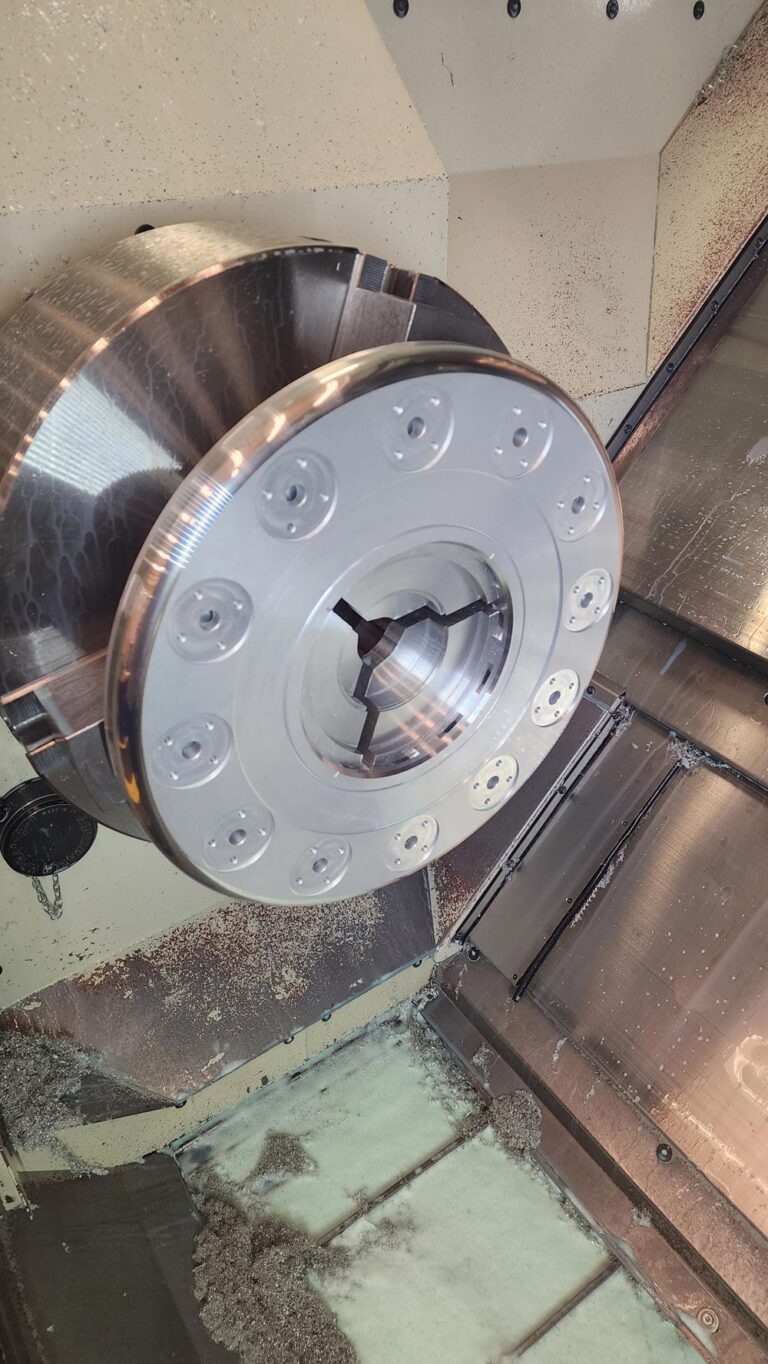 The end setup on the CNC lathe, showing work on the plasma chamber’s flange. 