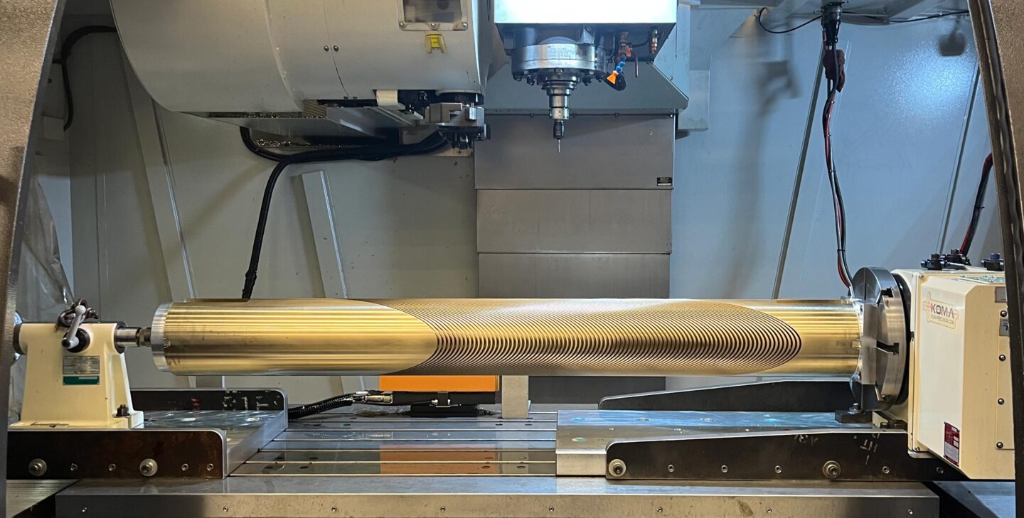 The completed aluminum-bronze mandrel, sitting within the hood of the CNC machine.
