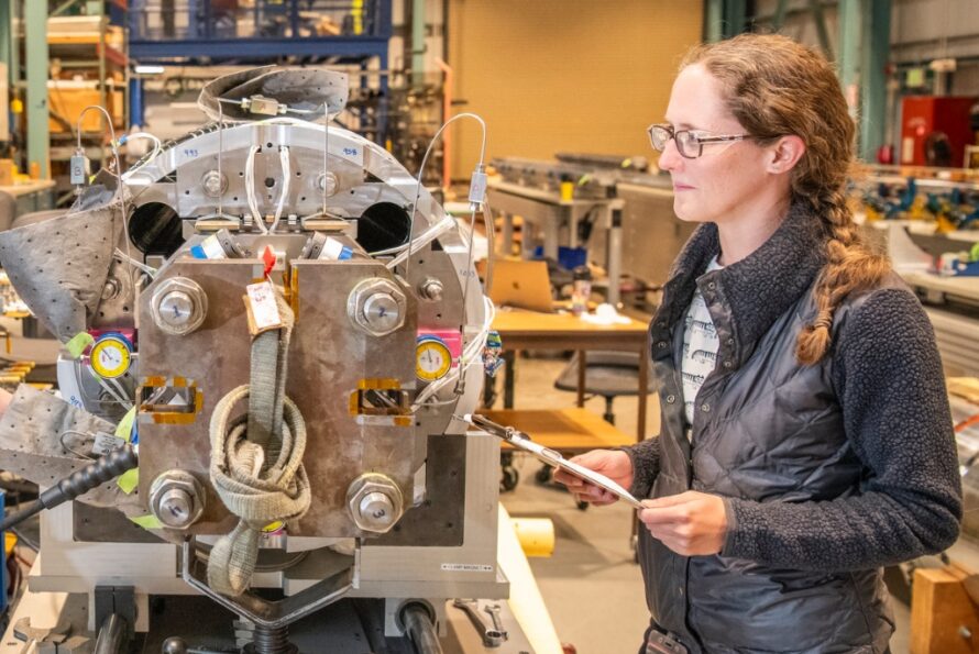 Jennifer Doyle with a magnet for the High-Luminosity Large Hadron Collider Accelerator Upgrade Project.