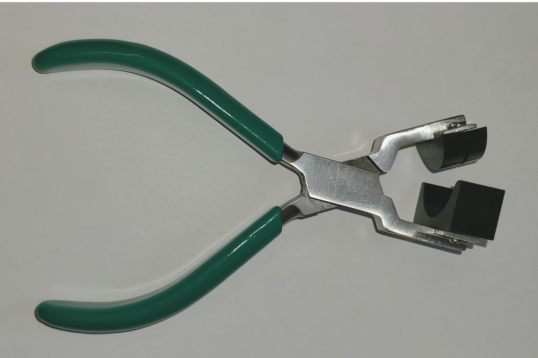 A plier-like tool with a custom nose designed to bend superconducting wire at a precise angle.