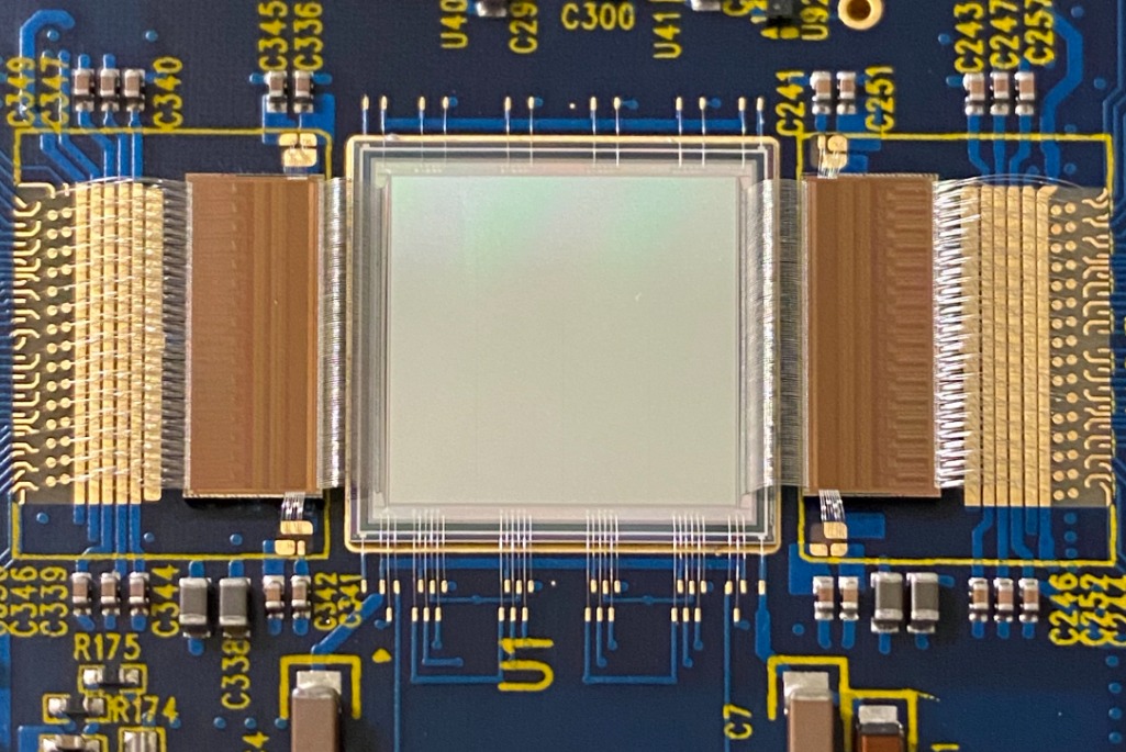 Detailed view of delicate wire bonding work connecting an image sensor and two custom readout chips for the VeryFastCCD project.