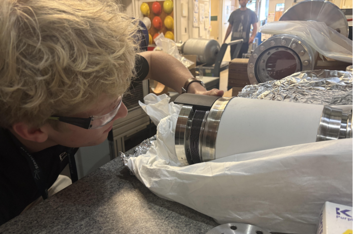 Brandon Osborn test fitting a 3D printed prototype for a bellows clam shell clamp.