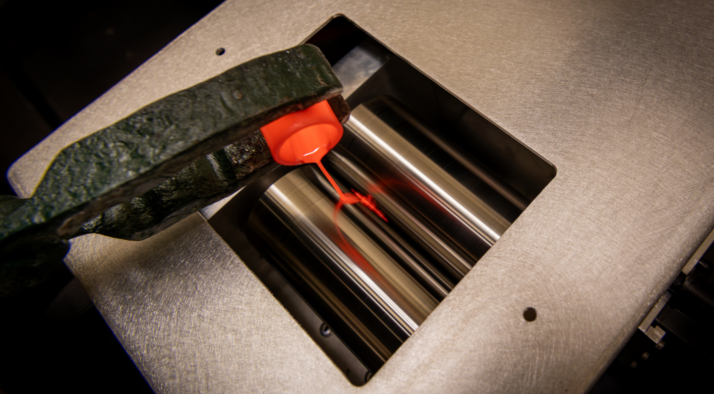 Molten material being poured between the twin roller quencher’s “pasta rollers.”