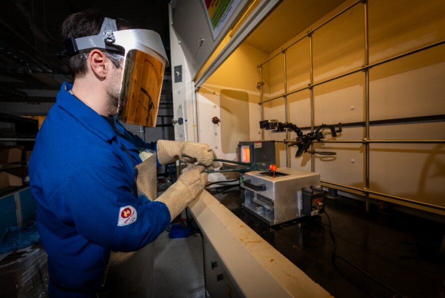 Research scientist Andrew Dopilka pouring molten material into a twin roller quencher, a device custom-made for his research.