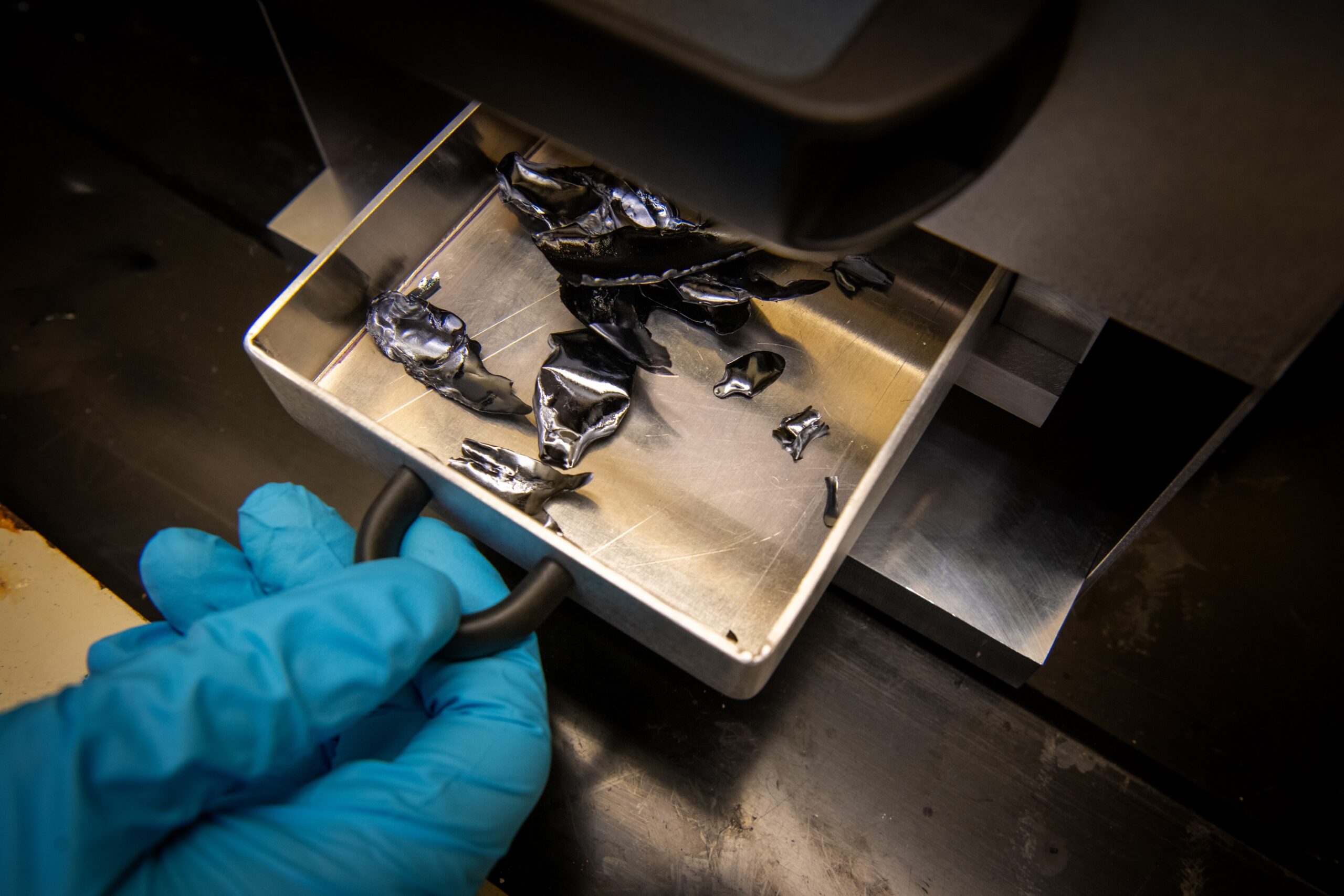 The final product of twin roller quencher: slightly curved flakes of amorphous material that will be ground into a powder.