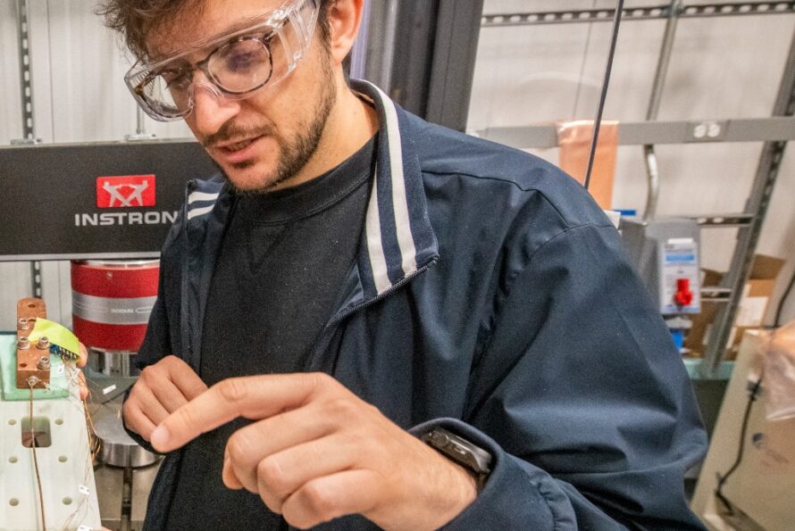 Giorgio Vallone, a research scientist in Berkeley Lab’s Engineering Division, examines part of a superconducting magnet.